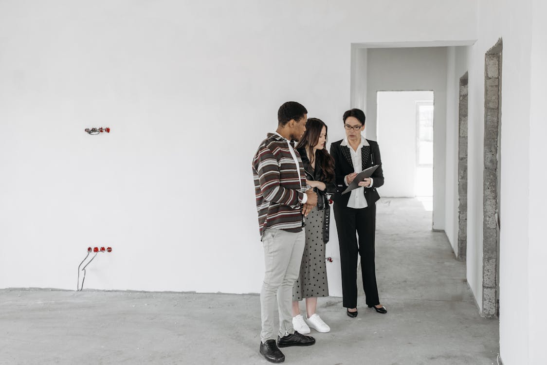 A real estate agent showing a couple around a house 